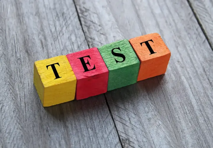 Kolorowe klocki z literami tworzą napis "TEST". Może to być test na neofobię żywieniową, sprawdzający gotowość do próbowania nowych smaków.